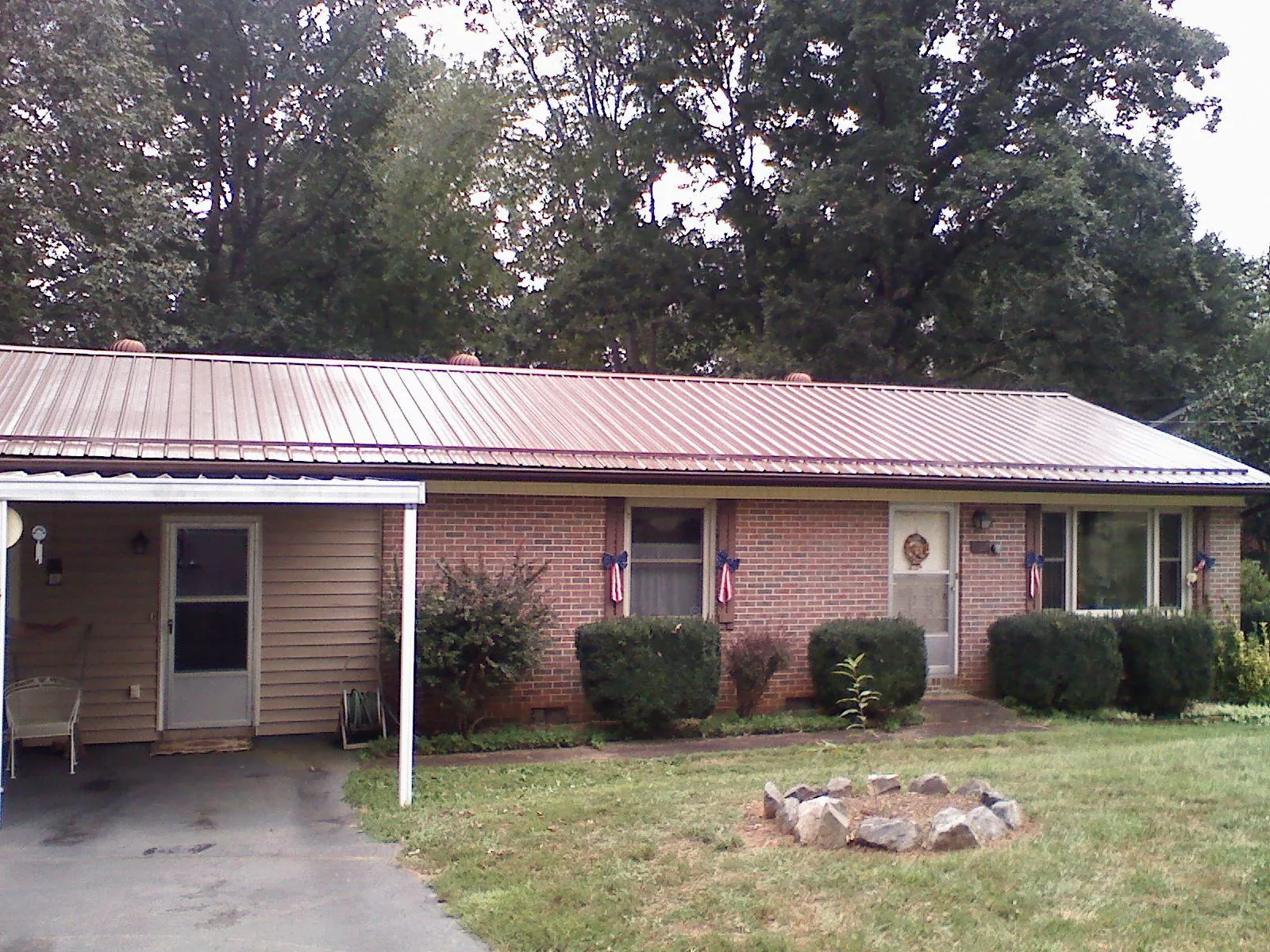 Bronze metal roof and carport on a brick ranch home — Roof Repair work by our crew in Winthrop Harbor